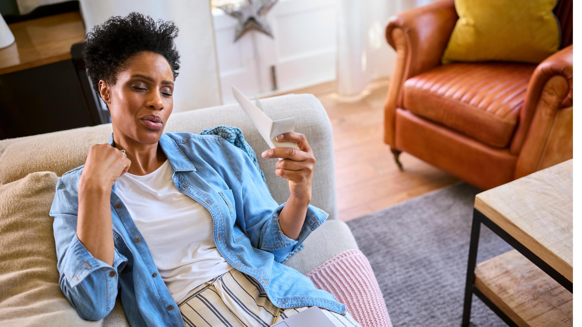 Woman lying on the couch experiencing a hot flash.